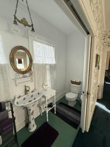 a white bathroom with a sink and a toilet at Shaw House Inn in Ferndale