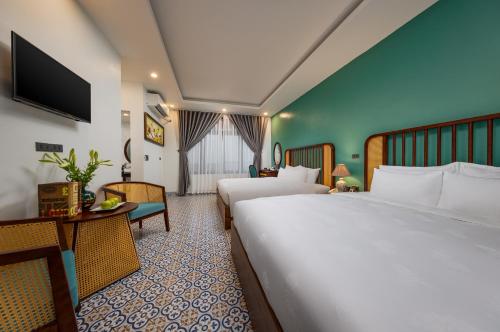 En eller flere senge i et værelse på Tam Coc Condelux Boutique Hotel