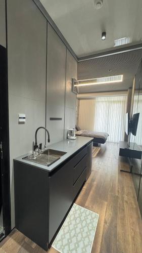 a kitchen with a sink and a counter top at Premium Smart Studio with River View in Tbilisi City