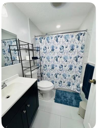 a bathroom with a toilet and a shower curtain at Nice private room with separate entrance in Port Richey