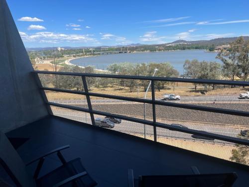 a balcony with a view of a body of water at Luxe 1 BR Retreat Lake Views at Nishi New Acton Canberra City in Canberra
