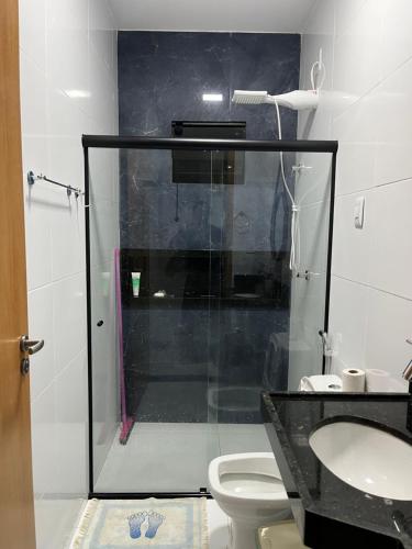 a bathroom with a shower with a toilet and a sink at CASA MARECHAL FRANCÊs in Marechal Deodoro