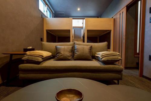 a living room with a couch with pillows on it at PREMIUM O2stay citrus onomichi in Onomichi