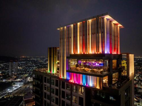 a building with lights on the side of it at night at Oakwood Hotel & Residence Sri Racha in Si Racha