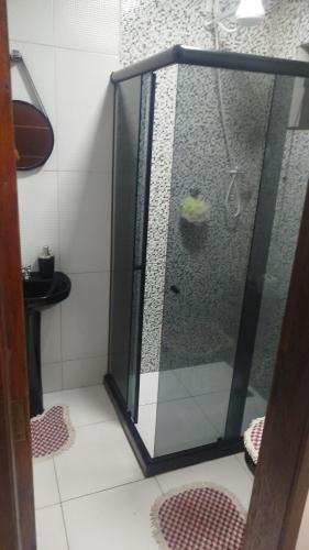 a shower with a glass door in a bathroom at Aconchego da Maria 2! in Mangaratiba