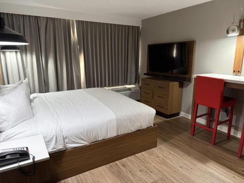 a hotel room with a bed and a flat screen tv at Hotel Kiva, an Ascend Collection Hotel in Albuquerque