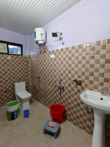 a bathroom with a sink and a toilet at Bilju Homestay in Munsyari