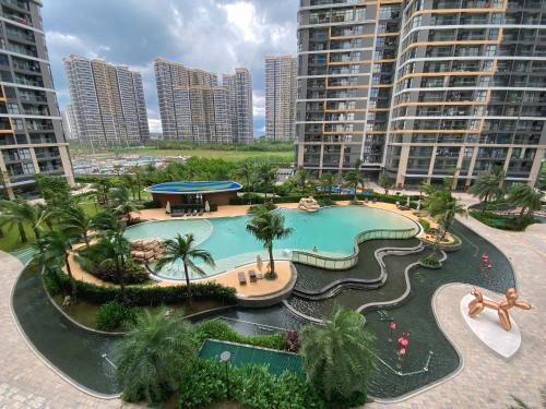 een groot zwembad in een resort met hoge gebouwen bij BedKing Beverly VIP Luxury in Long Bình