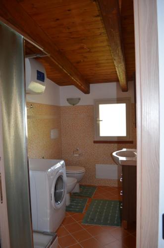 a bathroom with a toilet and a sink at Terrazza sul golfo degli angeli in Capitana