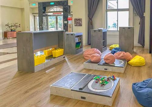 a room with a tv and some donuts on the floor at Jade Garden Hotel - 翠華會館 in Gukeng