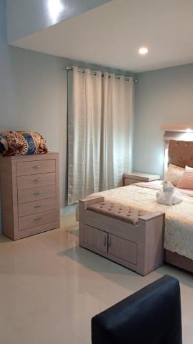 a bedroom with a large bed and a dresser at Cuarto Privado in Arandas