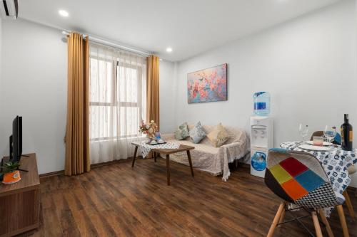 a living room with a couch and a table at Nagomi Residence in Hanoi