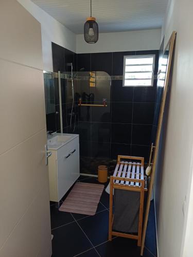 a small bathroom with a shower and a bench in it at Kevio in Chambort