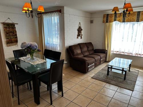 a living room with a table and a couch at Los Castaños Pucón in El Cerrillo