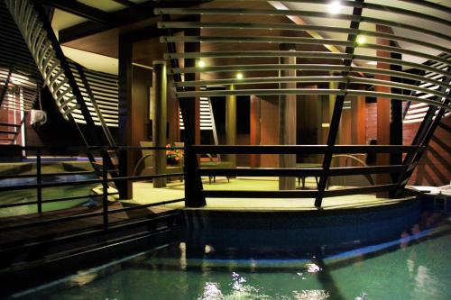 a pool of water in a building with a staircase at Bali Umah Tinjung in Tulamben