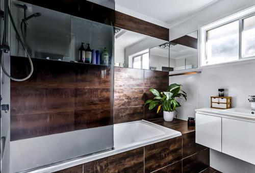 a bathroom with a bath tub and a sink at The Unit Lennox Head in Lennox Head