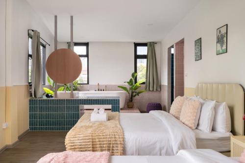 a bedroom with a bed and a bathroom with a sink at MIQ Ekkamai1 - 5BR house 65 inch TV in Bangkok