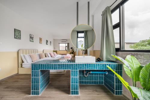 a living room with a blue table and a mirror at MIQ Ekkamai1 - 5BR house 65 inch TV in Bangkok
