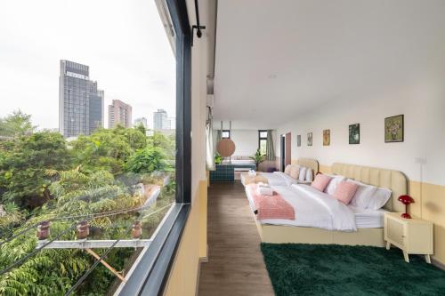 a room with a bed and a large window at MIQ Ekkamai1 - 5BR house 65 inch TV in Bangkok
