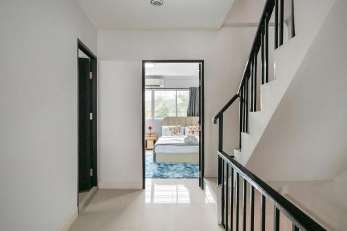 a hallway leading to a bedroom with a bed at MIQ Ekkamai1 - 5BR house 65 inch TV in Bangkok