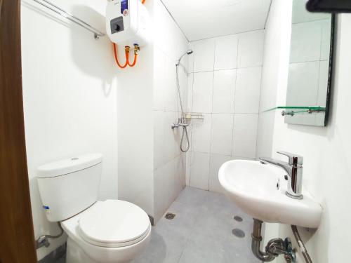 a bathroom with a toilet and a sink at Royal Sentul Al Alami in Kedungmanggu