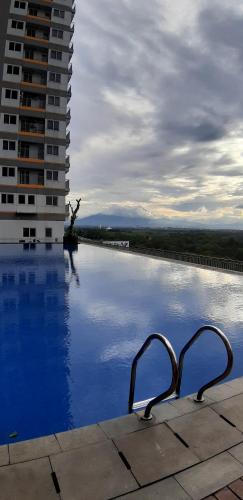 a view of a swimming pool with a building at Royal Sentul Al Alami in Kedungmanggu