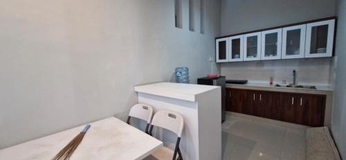 a kitchen with a counter and a table and chairs at Spacious 3BR Villa in Jembrana in Mendaya