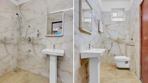 a bathroom with two sinks and a toilet at Hill Hara in Tirupati