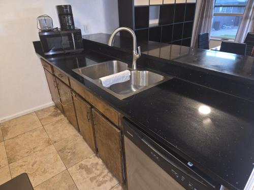 a kitchen counter with a sink and a microwave at Sunshine village in Euless
