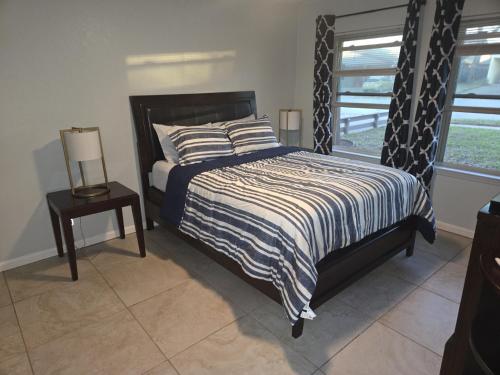 a bedroom with a bed with a black and white comforter at Sunshine village in Euless