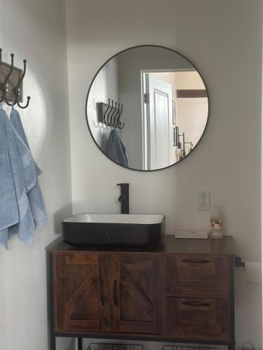 a bathroom with a black sink and a mirror at Modern barn by the creek in Evergreen