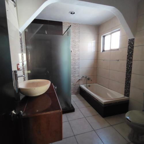 a bathroom with a sink and a bath tub at Casa Aleymar in Playa del Carmen