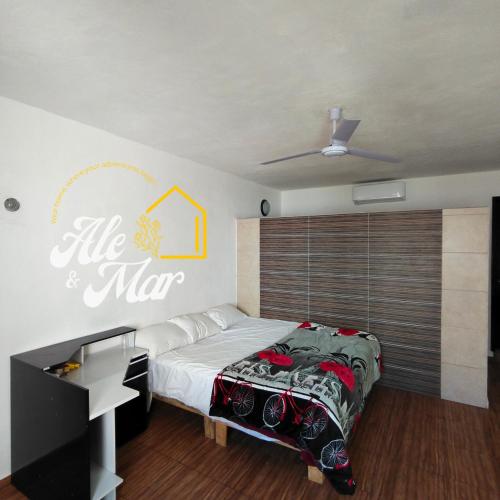 a bedroom with a bed and a sign that reads life is man at Casa Aleymar in Playa del Carmen