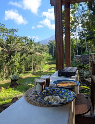 a table with a plate of food on it at Hide and Seek in Tetebatu