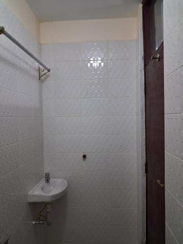 a white bathroom with a sink and a shower at Machakos Town studios in Machakos