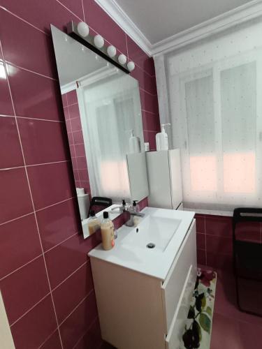 a bathroom with a sink and a mirror at Antonio del Toro in Lora del Río