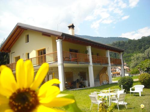 a house with a sunflower in front of it at Agriturismo Il Girasole in Feltre