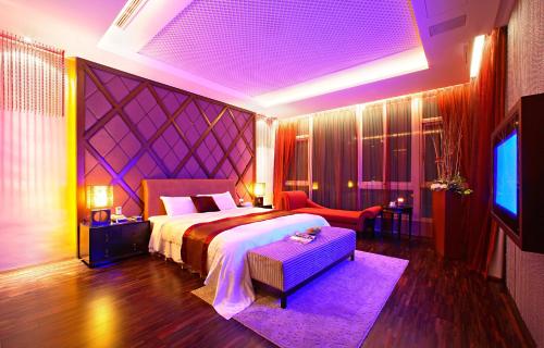 a bedroom with a large bed and a tv at Changhua Laurel Boutique Motel in Changhua City