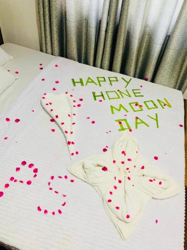 a happy have a new year sign on a bed with hearts at Gold Stream Villa in Demodara