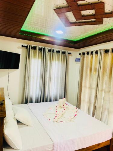 a bedroom with a bed with a cake on it at Gold Stream Villa in Demodara