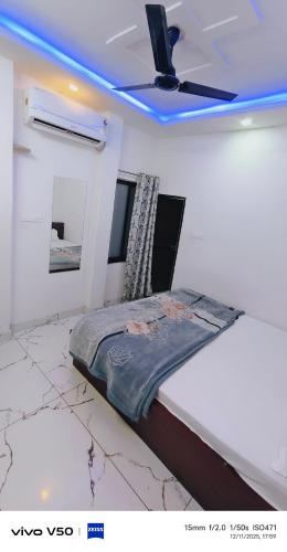 a bed in a room with a ceiling fan at Vishal guest house in Juliāsar