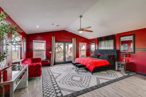 a bedroom with red walls and a bed and a couch at 3-Acre Retreat, 3 Mi to Dtwn Jensen! Upscale Home in Jensen Beach