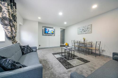 a living room with a couch and a table at 2AA Spacious & Innovative Stay in Beeston