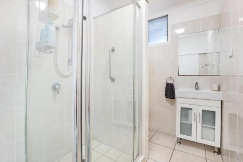 a bathroom with a shower and a sink at 1/24 Birch Street in Amity Point
