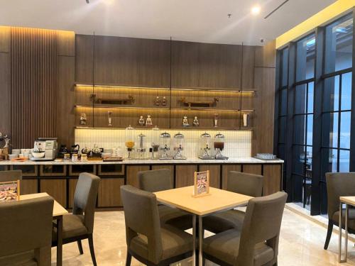a kitchen with a table and chairs and a counter at Citadines Connect Airport Jakarta Hotel in Tangerang