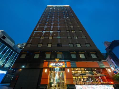 a tall building with a nordstrom sign on it at APA Hotel Shinjuku Kabukicho Chuo in Tokyo