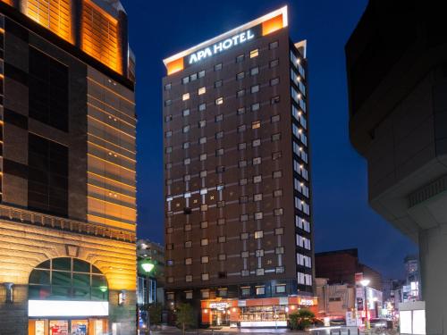 a hotel building with a new hotel sign on it at APA Hotel Shinjuku Kabukicho Chuo in Tokyo
