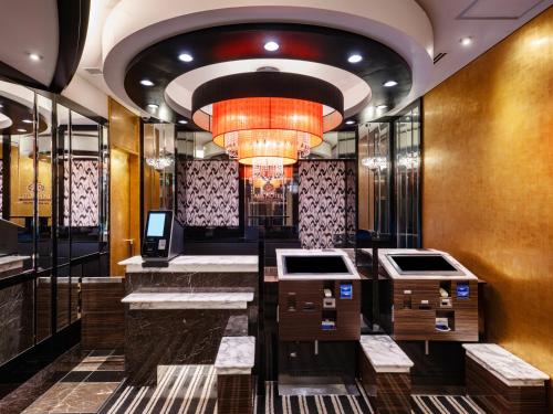 a lobby of a hotel with a chandelier at APA Hotel Shinjuku Kabukicho Chuo in Tokyo