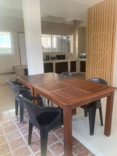 a wooden table and chairs in a room at Nai Yang Guest House in Nai Yang Beach