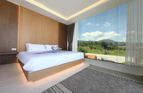 a bedroom with a large bed and a large window at Tropical Luxury Samui Villa Donava in Nathon Bay